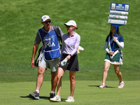 Sarah Schmelzel of Phoenix, Arizona walks with her caddie followed by the standard bearer on the 18th fairway during the second round of the...