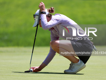 Sarah Schmelzel of Phoenix, Arizona places her ball on the 18th green during the second round of the KPMG Women's PGA Championship at Sahale...