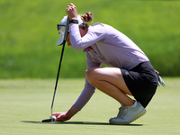 Sarah Schmelzel of Phoenix, Arizona places her ball on the 18th green during the second round of the KPMG Women's PGA Championship at Sahale...