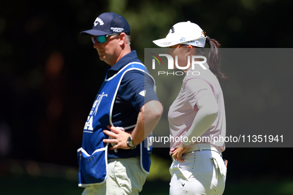 Ruoning Yin of China looks over the 2nd green with her caddie during the second round of the KPMG Women's PGA Championship at Sahalee Countr...