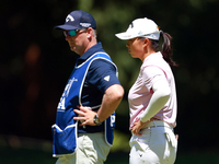 Ruoning Yin of China looks over the 2nd green with her caddie during the second round of the KPMG Women's PGA Championship at Sahalee Countr...