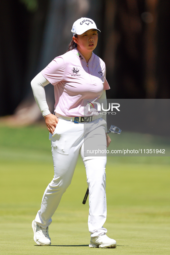 Ruoning Yin of China walks on the 2nd green with her caddie during the second round of the KPMG Women's PGA Championship at Sahalee Country...