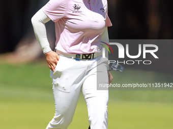 Ruoning Yin of China walks on the 2nd green with her caddie during the second round of the KPMG Women's PGA Championship at Sahalee Country...