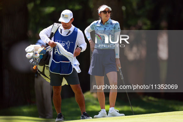 Alison Lee of Los Angeles, California waits with her caddie on the 6th green during the second round of the KPMG Women's PGA Championship at...