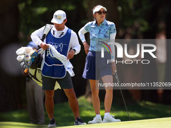 Alison Lee of Los Angeles, California waits with her caddie on the 6th green during the second round of the KPMG Women's PGA Championship at...