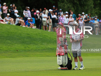 Lexi Thompson of the United States interacts with her caddy on the 18th hole during Day Three of the KPMG Women's PGA Championship at Sahale...