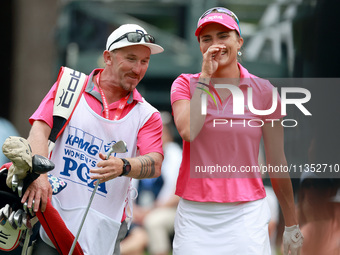 Lexi Thompson of Florida reacts to her shot from the 17th tee while walking with her caddie during the third round of the KPMG Women's PGA C...