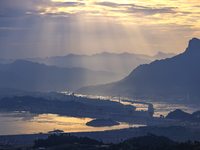 A golden sunrise is being seen over the Three Gorges Dam area in Yichang, China, on June 23, 2024, in the early morning. (