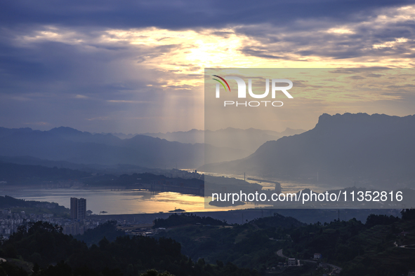 A golden sunrise is being seen over the Three Gorges Dam area in Yichang, China, on June 23, 2024, in the early morning. 