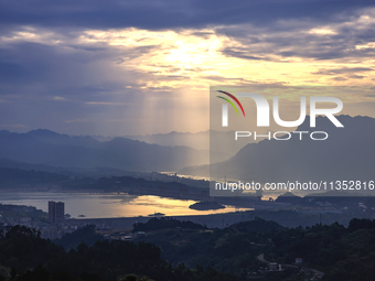 A golden sunrise is being seen over the Three Gorges Dam area in Yichang, China, on June 23, 2024, in the early morning. (