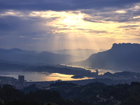 A golden sunrise is being seen over the Three Gorges Dam area in Yichang, China, on June 23, 2024, in the early morning. (