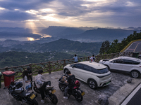 Tourists are watching the sunrise from a viewing platform on the Three Gorges Dam in Yichang, China, on June 23, 2024. (