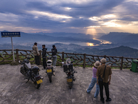 Tourists are watching the sunrise from a viewing platform on the Three Gorges Dam in Yichang, China, on June 23, 2024. (