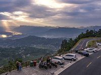 Tourists are watching the sunrise from a viewing platform on the Three Gorges Dam in Yichang, China, on June 23, 2024. (