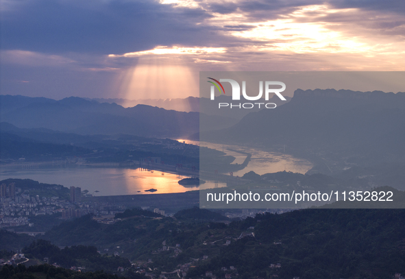 A golden sunrise is being seen over the Three Gorges Dam area in Yichang, China, on June 23, 2024, in the early morning. 