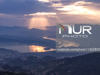 A golden sunrise is being seen over the Three Gorges Dam area in Yichang, China, on June 23, 2024, in the early morning. (