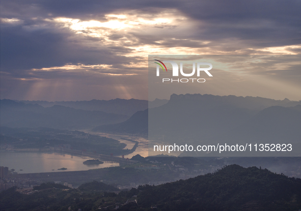 A golden sunrise is being seen over the Three Gorges Dam area in Yichang, China, on June 23, 2024, in the early morning. 