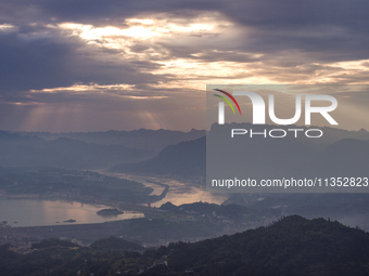 A golden sunrise is being seen over the Three Gorges Dam area in Yichang, China, on June 23, 2024, in the early morning. (