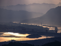 A golden sunrise is being seen over the Three Gorges Dam area in Yichang, China, on June 23, 2024, in the early morning. (