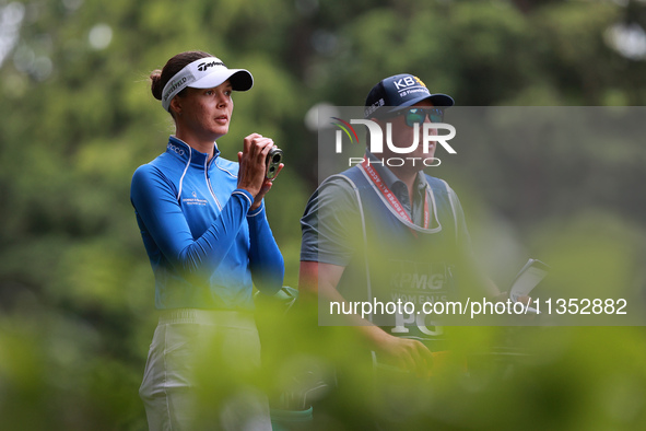 Esther Henseleit of Germany looks through a range finder on the 11th hole during Day Three of the KPMG Women's PGA Championship at Sahalee C...