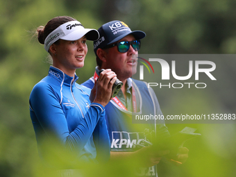 Esther Henseleit of Germany looks through a range finder on the 11th hole during Day Three of the KPMG Women's PGA Championship at Sahalee C...