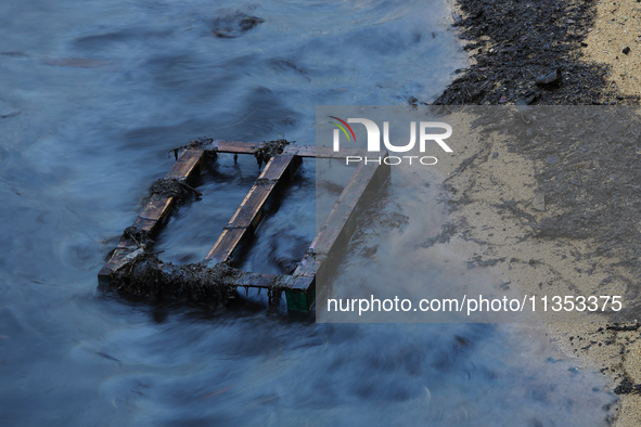 A general view is showing the oil sheen on the waters at East Coast Park beach in Singapore, on June 23, 2024. Singapore authorities are con...