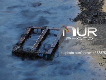 A general view is showing the oil sheen on the waters at East Coast Park beach in Singapore, on June 23, 2024. Singapore authorities are con...