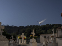 A firefighting aircraft is water bombing the wildfire that is breaking out in villages of the Ilia prefecture in ILEIA, Greece, on June 22,...