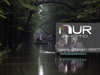 Tourists are riding a bamboo raft in the Golden Lake Water Forest Park in Huai'an, China, on June 22, 2024. (