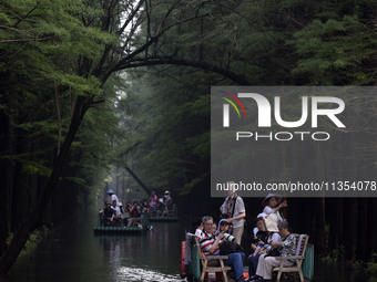 Tourists are riding a bamboo raft in the Golden Lake Water Forest Park in Huai'an, China, on June 22, 2024. (