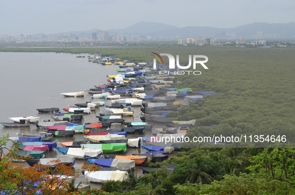 Fishing boats are being parked and covered with tarpaulin sheets in preparation for the upcoming monsoon season on the outskirts of Mumbai,...