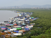 Fishing boats are being parked and covered with tarpaulin sheets in preparation for the upcoming monsoon season on the outskirts of Mumbai,...