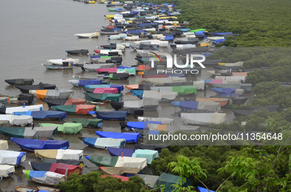 Fishing boats are being parked and covered with tarpaulin sheets in preparation for the upcoming monsoon season on the outskirts of Mumbai,...