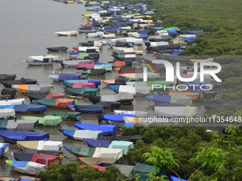 Fishing boats are being parked and covered with tarpaulin sheets in preparation for the upcoming monsoon season on the outskirts of Mumbai,...