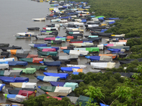 Fishing boats are being parked and covered with tarpaulin sheets in preparation for the upcoming monsoon season on the outskirts of Mumbai,...