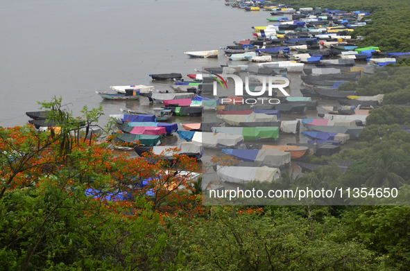 Fishing boats are being parked and covered with tarpaulin sheets in preparation for the upcoming monsoon season on the outskirts of Mumbai,...