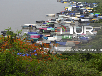 Fishing boats are being parked and covered with tarpaulin sheets in preparation for the upcoming monsoon season on the outskirts of Mumbai,...