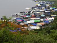 Fishing boats are being parked and covered with tarpaulin sheets in preparation for the upcoming monsoon season on the outskirts of Mumbai,...