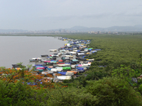 Fishing boats are being parked and covered with tarpaulin sheets in preparation for the upcoming monsoon season on the outskirts of Mumbai,...