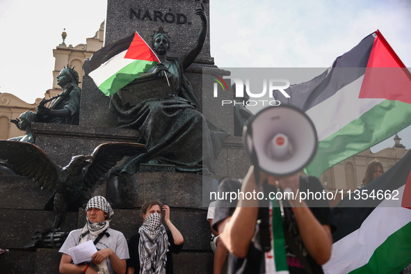 People attend solidarity with Palestine demonstration at the Main Square in Krakow, Poland on June 20th, 2024. 