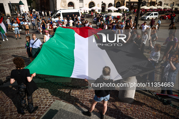 People attend solidarity with Palestine demonstration at the Main Square in Krakow, Poland on June 20th, 2024. 