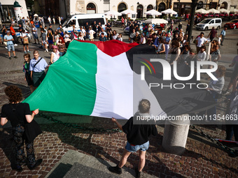 People attend solidarity with Palestine demonstration at the Main Square in Krakow, Poland on June 20th, 2024. (