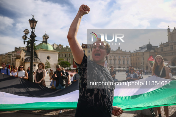 People attend solidarity with Palestine demonstration at the Main Square in Krakow, Poland on June 20th, 2024. 