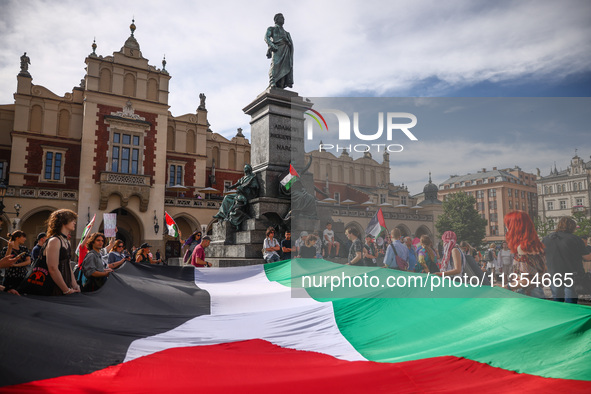 People attend solidarity with Palestine demonstration at the Main Square in Krakow, Poland on June 20th, 2024. 