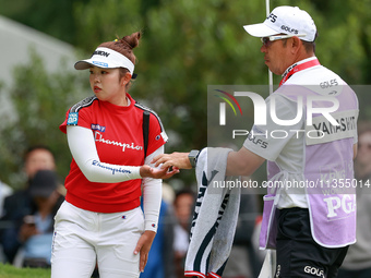 Miyu Yamashita of Japan takes her ball from her caddie on the 3rd green  during the final round of the KPMG Women's PGA Championship at Saha...