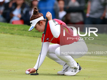 Miyu Yamashita of Japan places her ball on the 3rd green  during the final round of the KPMG Women's PGA Championship at Sahalee Country Clu...