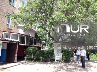 People are standing outside an apartment block after a Russian missile attack in Vasylkiv, Ukraine, on June 23, 2024. On Sunday morning, Jun...