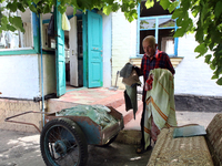 A man is throwing away damaged belongings outside a house after a Russian missile attack in Vasylkiv, Ukraine, on June 23, 2024. On Sunday m...