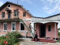 A woman and boy are standing at a house damaged by a Russian missile attack in Vasylkiv, Ukraine, on June 23, 2024. On Sunday morning, June...