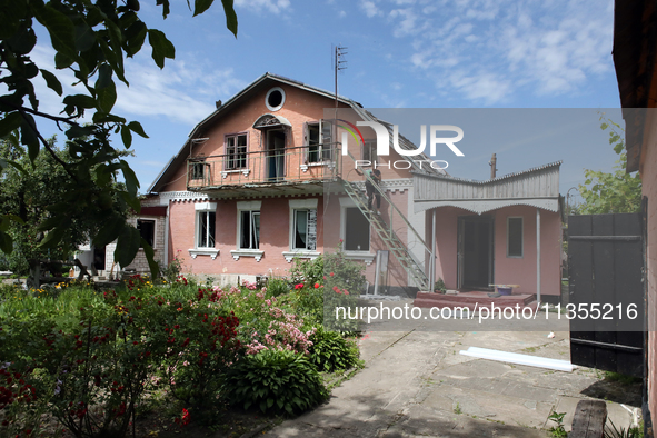 A woman is going down the stairs at a house damaged by a Russian missile attack in Vasylkiv, Ukraine, on June 23, 2024. On Sunday morning, J...